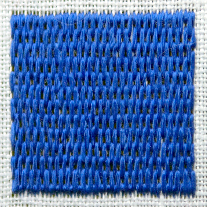 Carré brodé en bleu au point de brique, c'est à dire des points droits verticaux de même longueur disposés en quinconce.